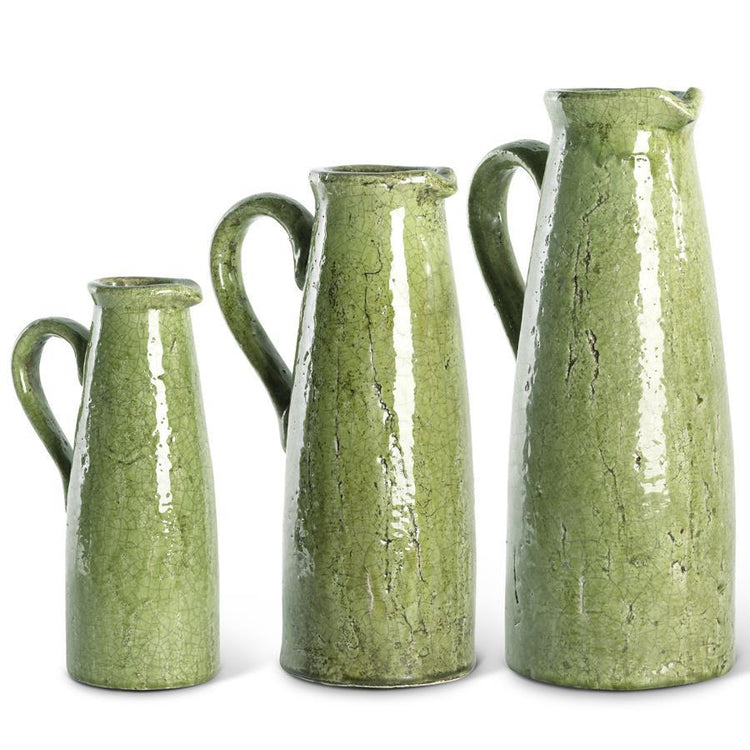 Terracotta green ceramic pitcher with a crackled glaze finish.