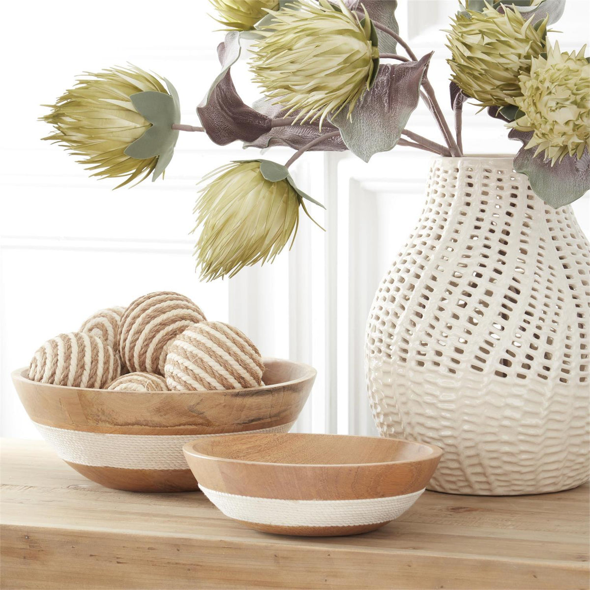 White ceramic vase with a basket weave textured surface.