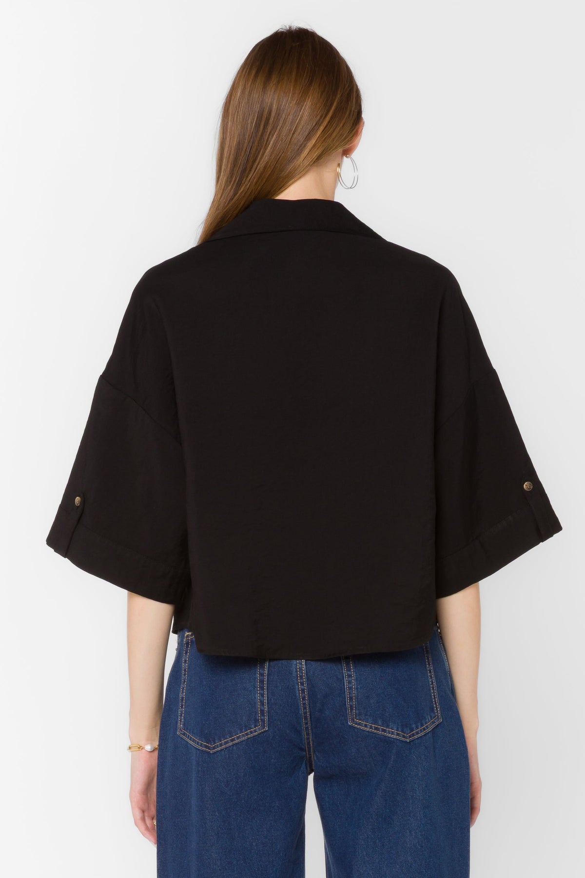 Minx Shirt in light blue viscose blend with collared neckline, front buttons, and high-low hem.