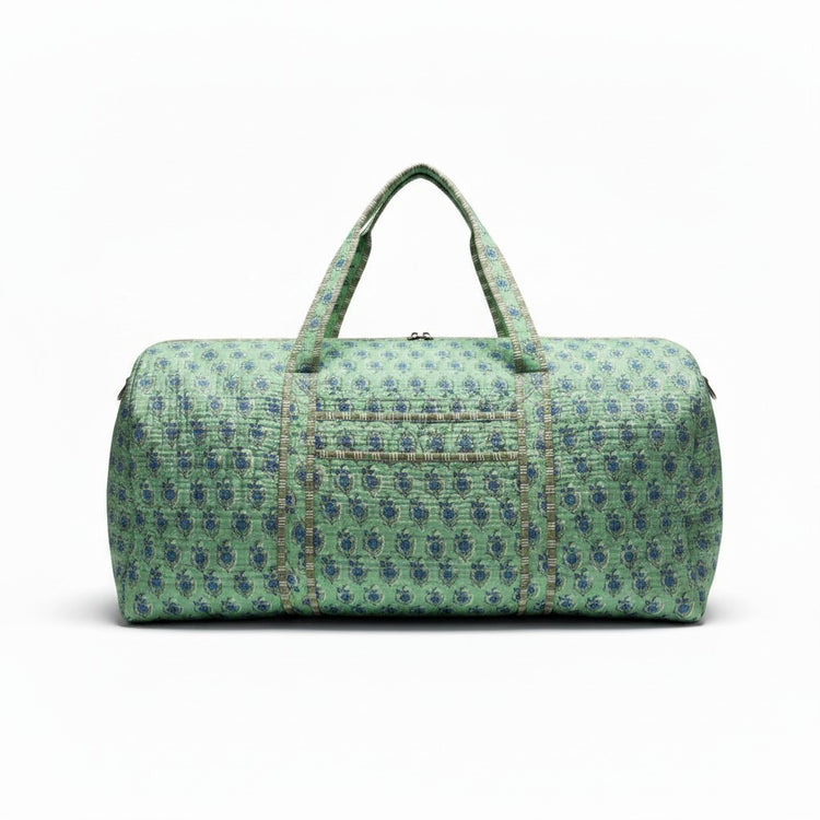 Teal quilted duffel bag with a blue floral pattern and matching top handles.
