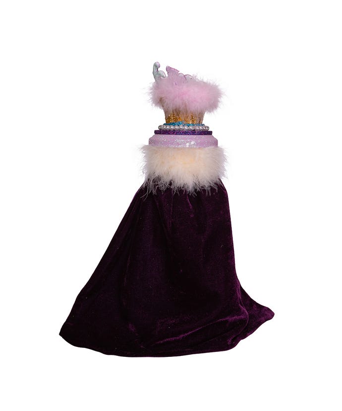 Back view of a nutcracker's purple velvet cape with white and pink faux fur trim and pearl details.