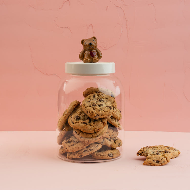 Large glass Super Duper Canister with a white lid and teddy bear mini, filled with cookies.