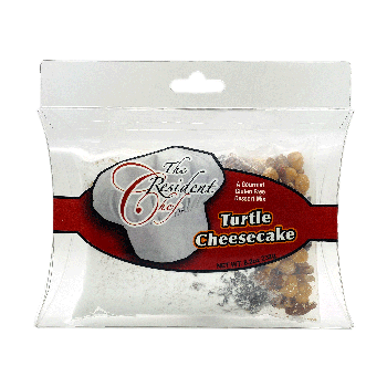 Turtle Cheesecake dessert mix package featuring caramel, pecan pieces, chocolate chips, and cream cheese.