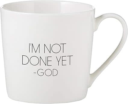 Bone China cafe mug with 'I am not done yet' text in white script on a light beige background.