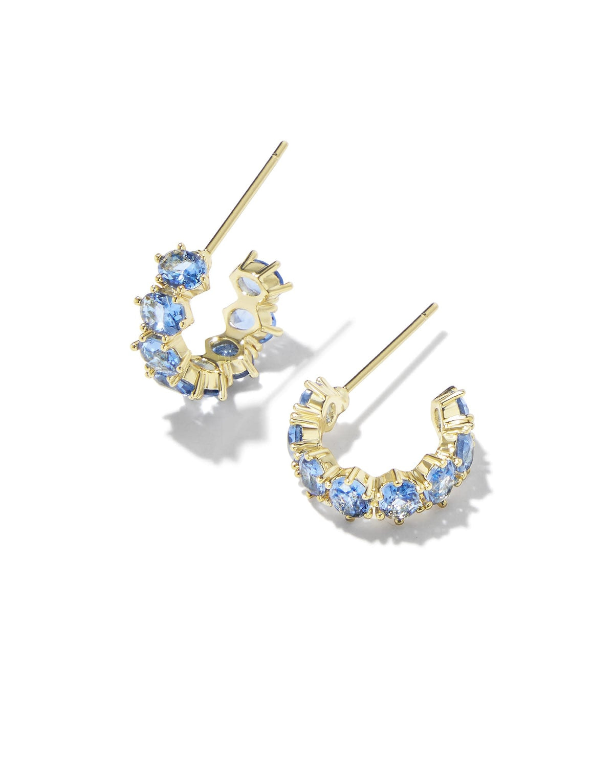 Gold huggie earrings featuring blue violet crystal accents with an earpost closure.