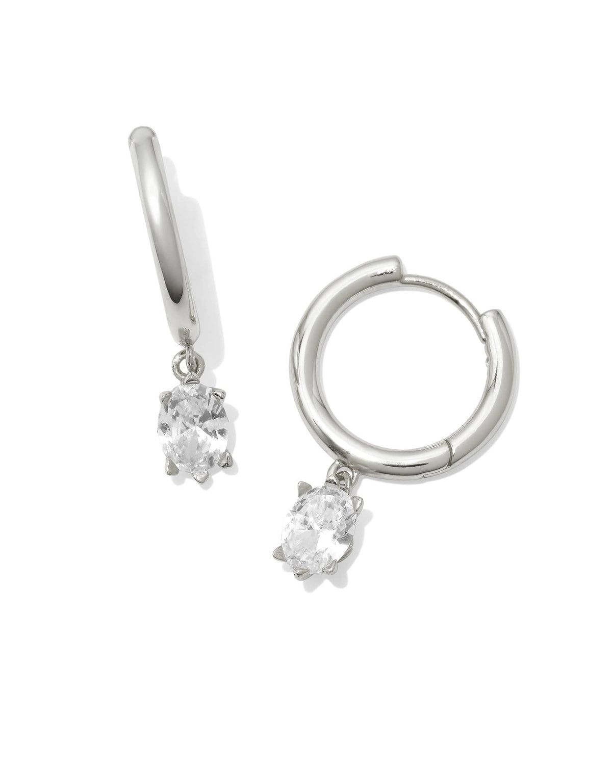 Silver huggie earrings with a single dangling crystal accent