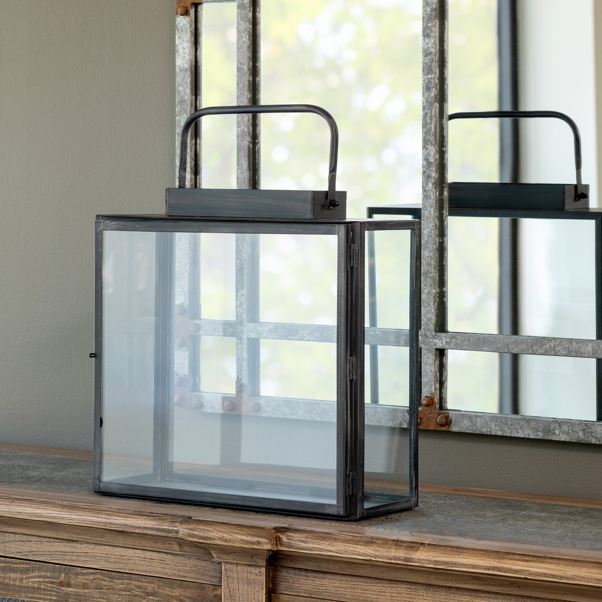 Antique black lantern with a classic geometric wireframe frame and frosted glass panels.