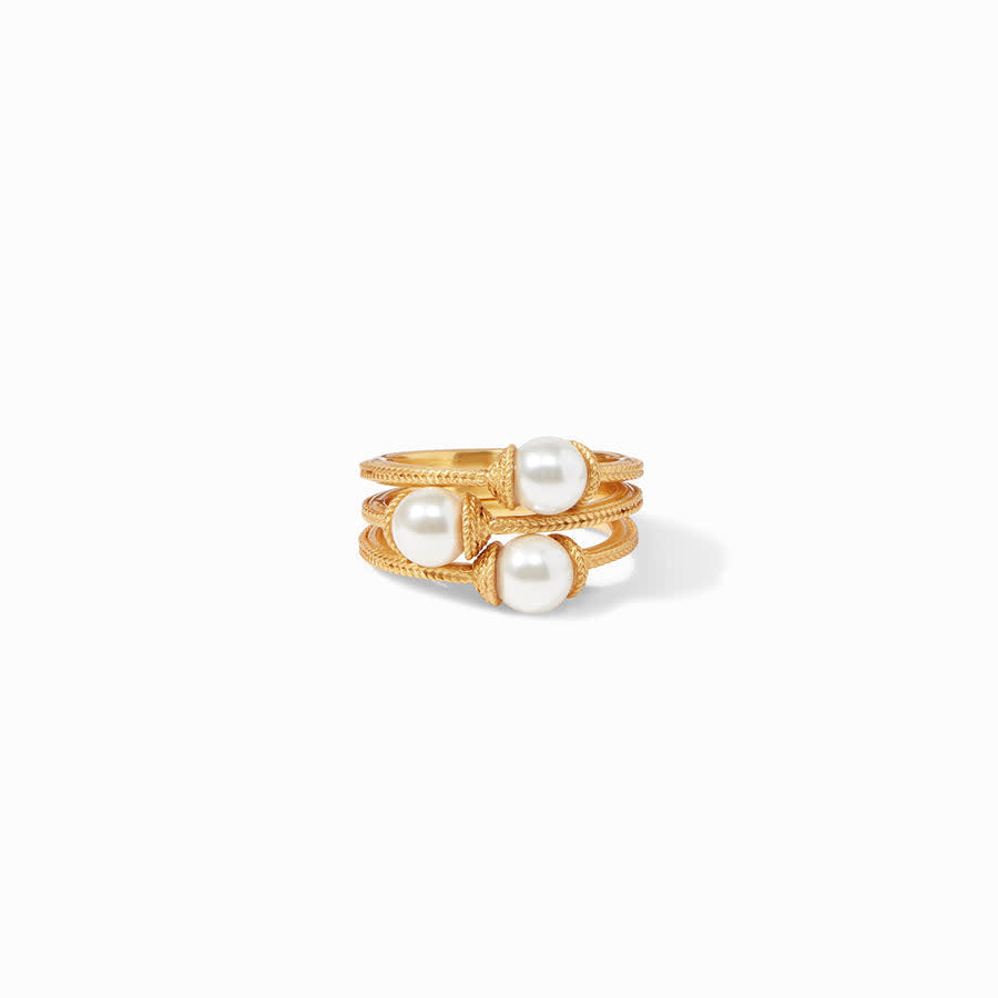 Three stacked Calypso rings in gold with a central pearl accent.