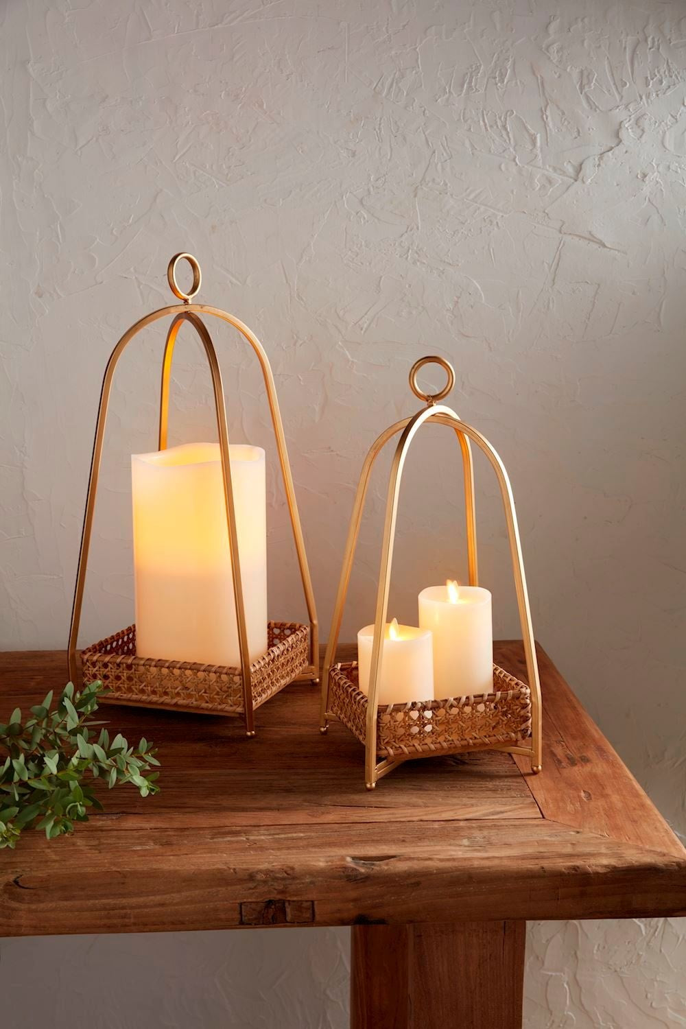 Bronze metal lantern with a woven cane candle tray insert.