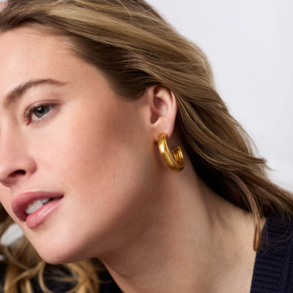 Gold-plated hoop earring with a sleek circular silhouette