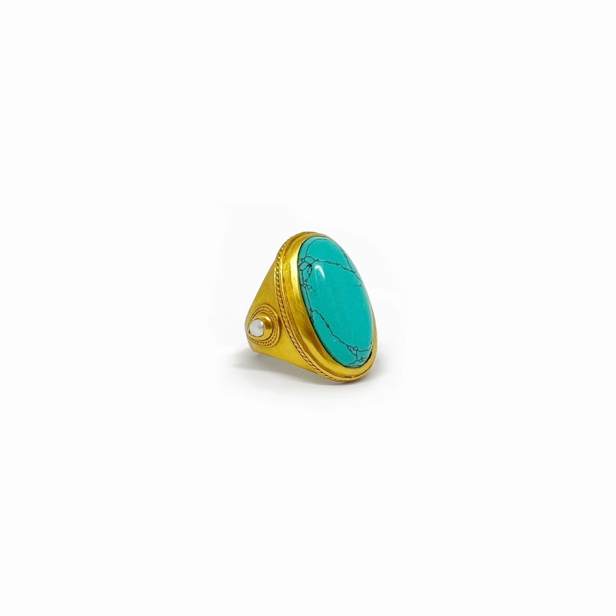Gold plated Cannes statement ring featuring a pear-shaped turquoise gemstone with mother-of-pearl accents and twisted wire detail.