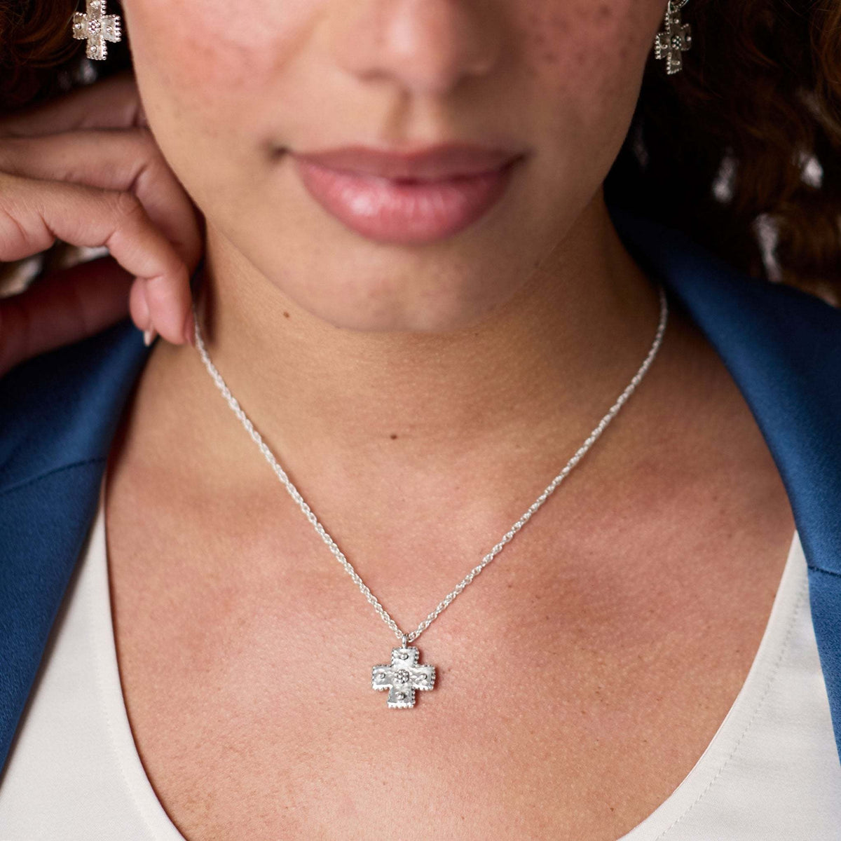 Silver adjustable necklace with hand-hammered cross pendant featuring bead accents