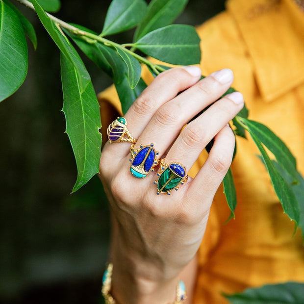 Gold ring band featuring a scarab amulet with polished lapis wings, turquoise head, and tiny feet.