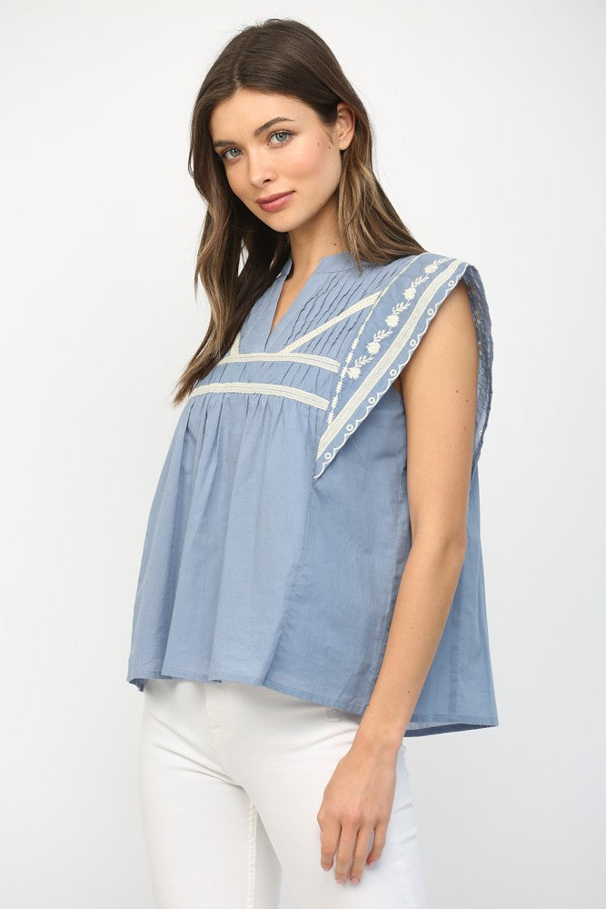 Leah ruffle sleeve blouse in white cotton with tape accents and embroidery.