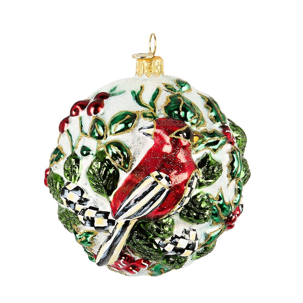 Hand-painted mouth-blown glass ornament shaped like a red cardinal with brass logo charm.