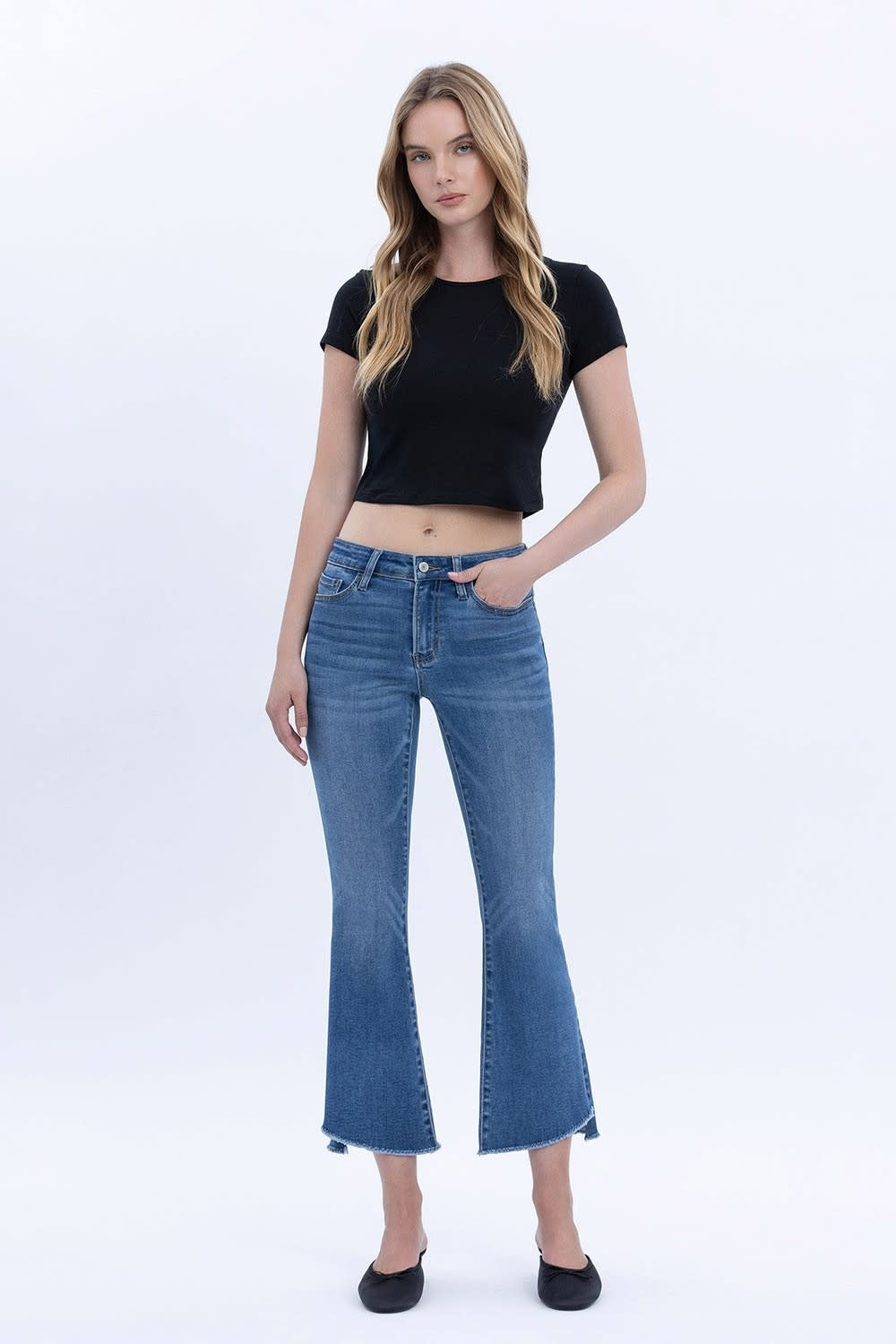 Front view of mid-rise Carmen crop flare jeans in stretch denim with a raw step hem.