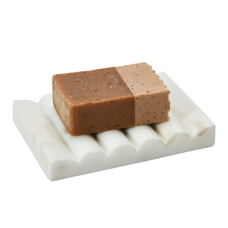 White carved marble soap dish with a groove drainage design