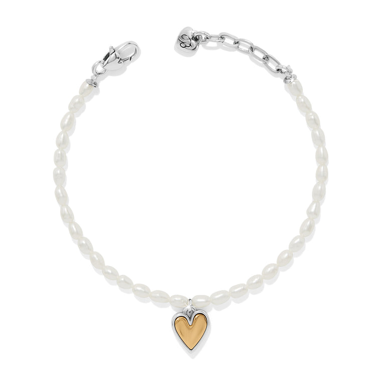 Adjustable gold-tone two-tone rice pearl bracelet featuring a heart-shaped pendant closure.