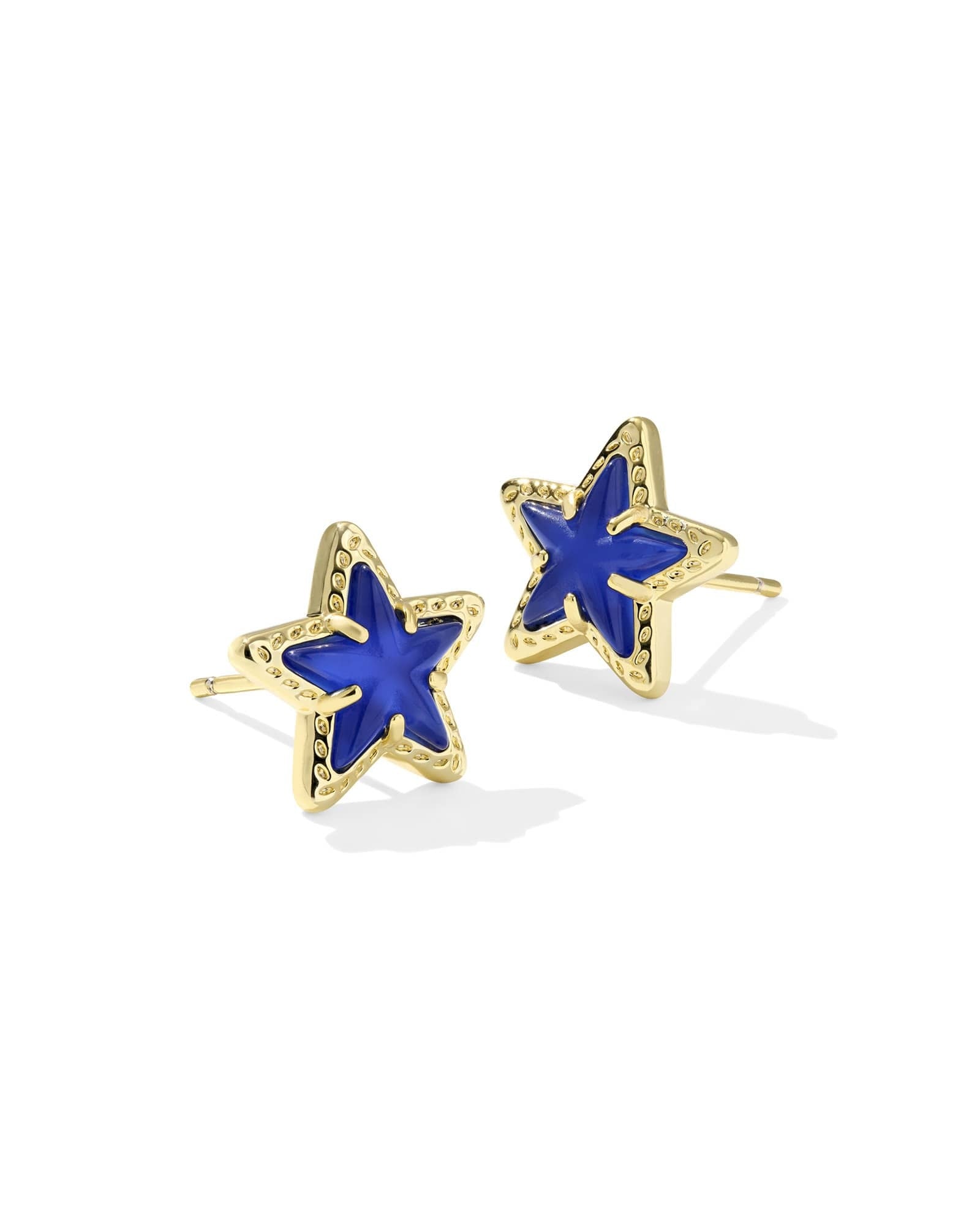 Gold Cassidy stud earrings featuring a cobalt blue illusion starburst pattern on the front face.