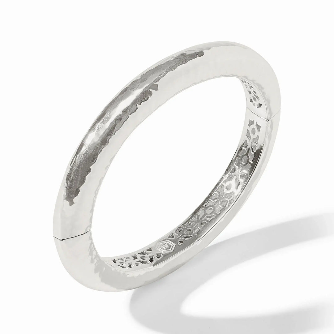 Silver hammered oval hinge bangle with a worn finish