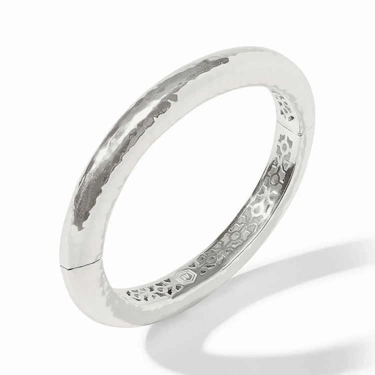 Silver hammered oval hinge bangle with a worn finish
