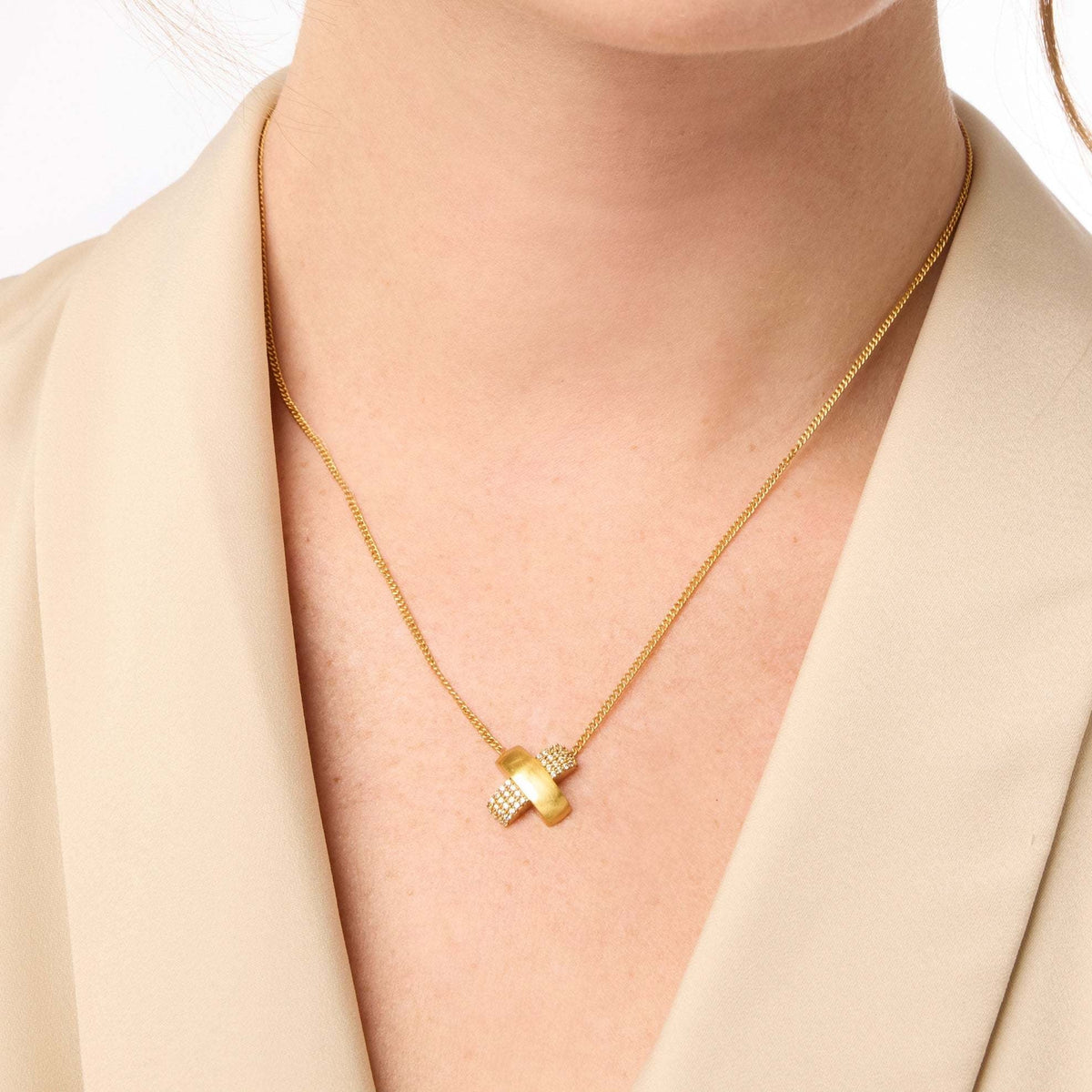 Delicate Catalina X necklace with pavé cubic zirconia stones on adjustable 24K gold plate chain.