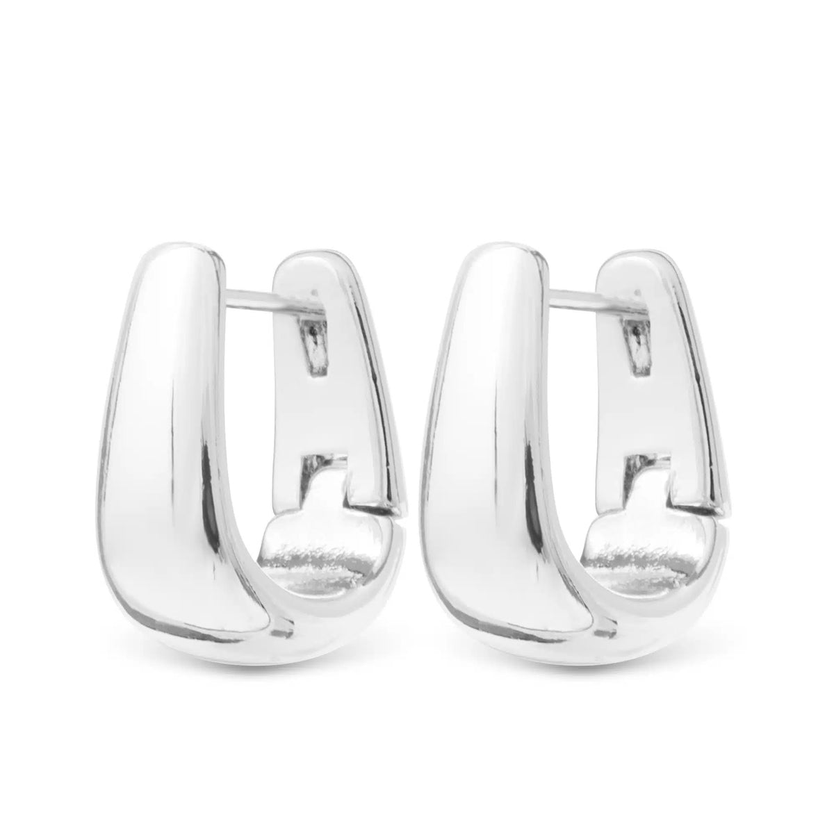 Pair of silver polished Edna elongated huggie earrings with a sleek, curved design.