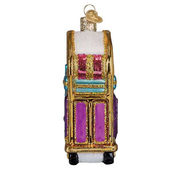 Stacked pastel suitcase ornament with golden wheels on a luggage cart base