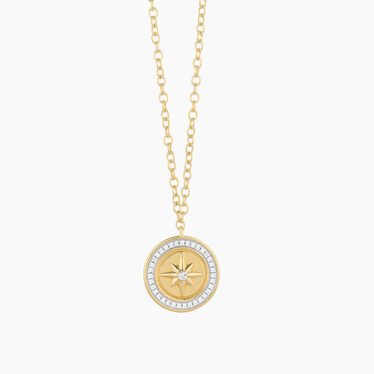 Sterling silver compass pendant necklace with gold-plated finish on a chain