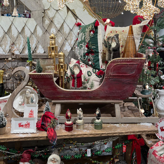 Sleigh Wood Metal bench with curved wooden frame and metal slat seat in natural finish.