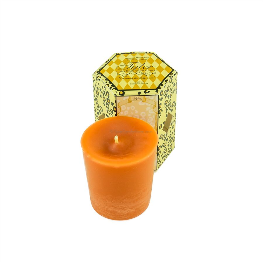 Orange votive candle in front of a hexagonal box with a yellow and black leopard print pattern.