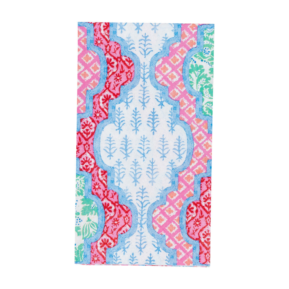 Guest towel napkin with a blue quatrefoil pattern and pink, red, and green floral block prints.