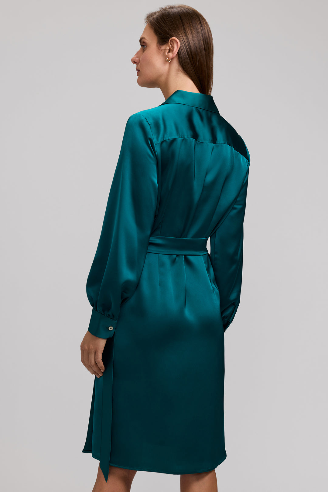 Back view of a woman wearing the Valentina teal glossy satin wrap dress with long sleeves.
