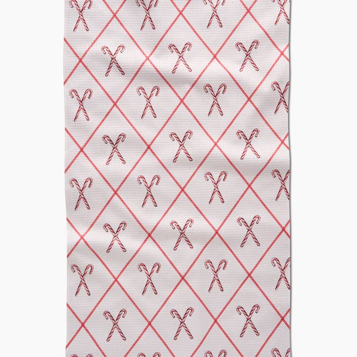 Holiday tea towel with waffle weave construction in red featuring festive snowflake pattern