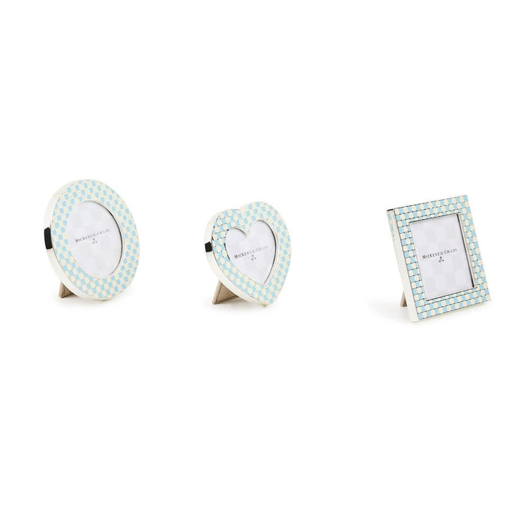 Set of three assorted silver-plated frames in baby blue enamel checks with ivory accents; heart, circle, and square silhouettes.
