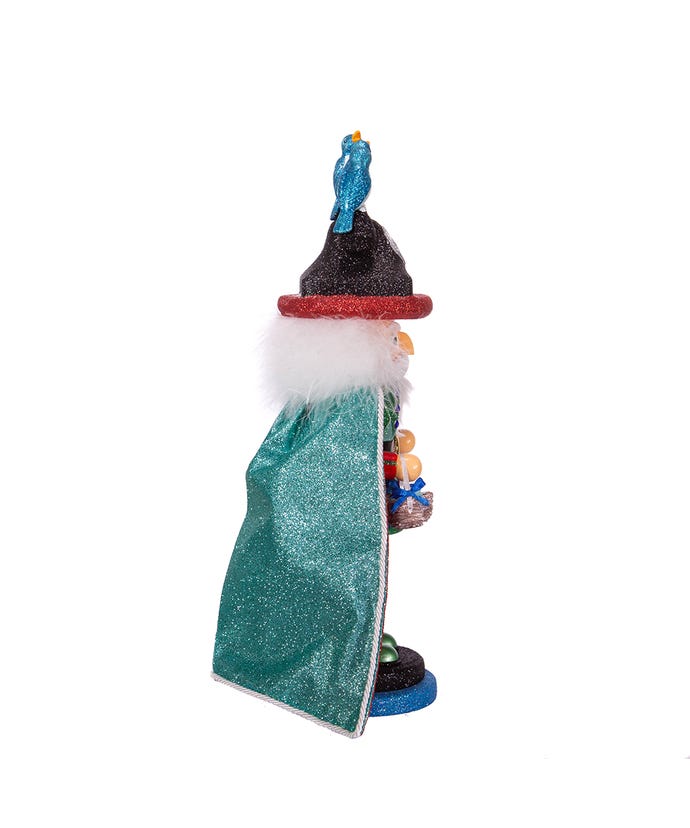 Side view of a 17.5-inch glittery Hollywood nutcracker wearing a teal cape and a bird-topped hat.
