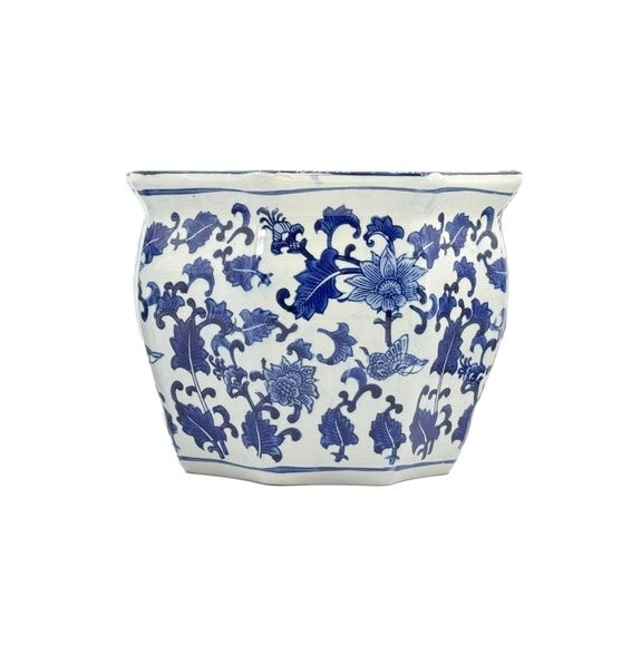 Blue and white ceramic planter pot with intricate fluting and chinoiserie-inspired hand-painted design.