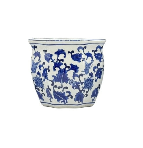 Blue and white ceramic planter pot with fluted sides and chinoiserie-inspired hand-painted design.