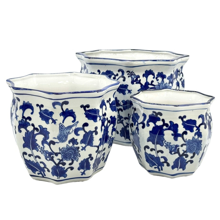 Blue and white ceramic planter pot with fluted sides and Chinoiserie-inspired hand-painted details.