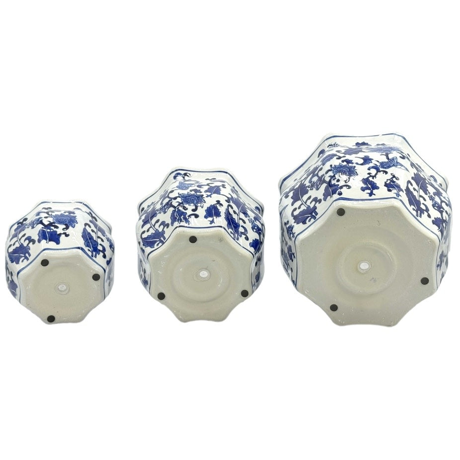 Blue and white ceramic planter pot with intricate fluting and chinoiserie-inspired hand-painted design.