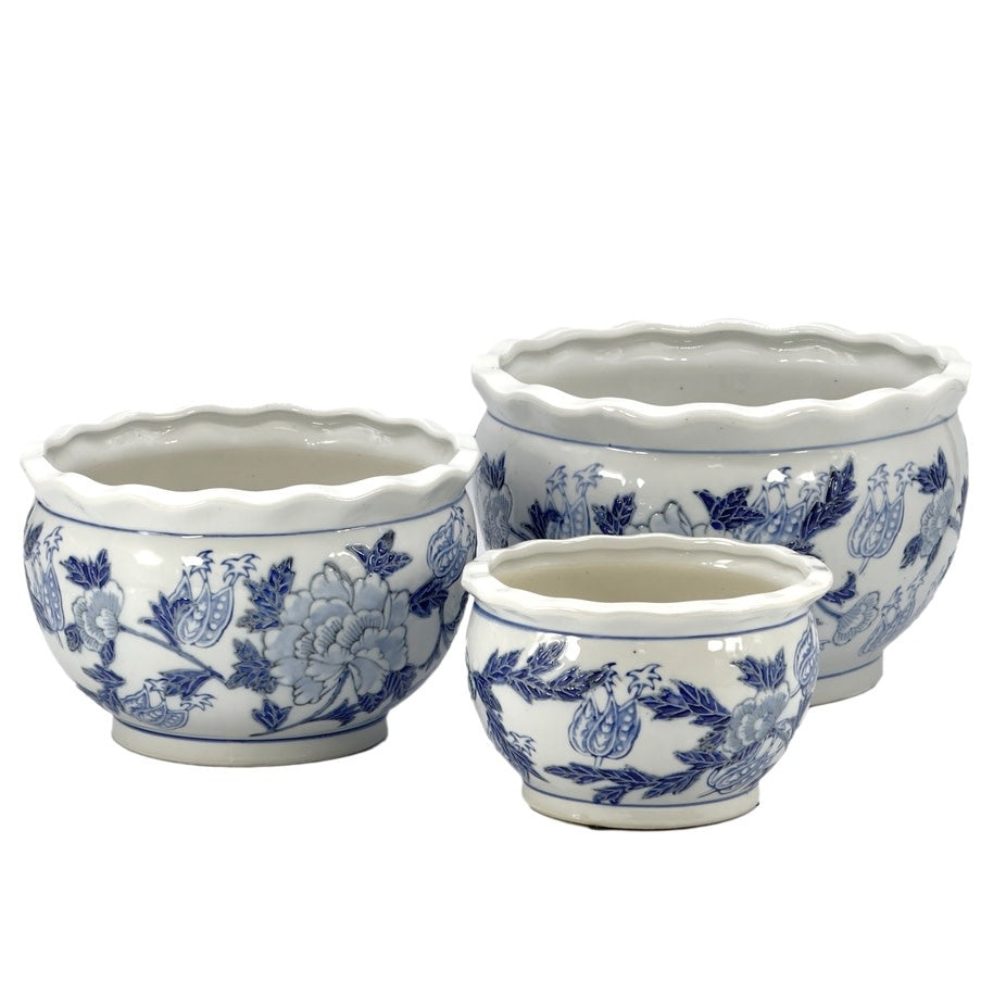 Round ceramic planter pot in blue and white with fluted sides and chinoiserie-inspired glaze.