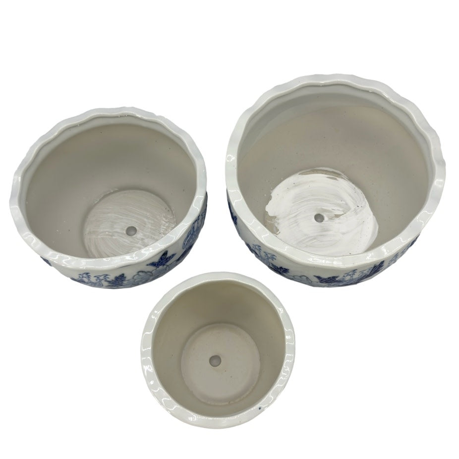 Round ceramic planter pot in blue and white Chinoiserie pattern with fluted sides.