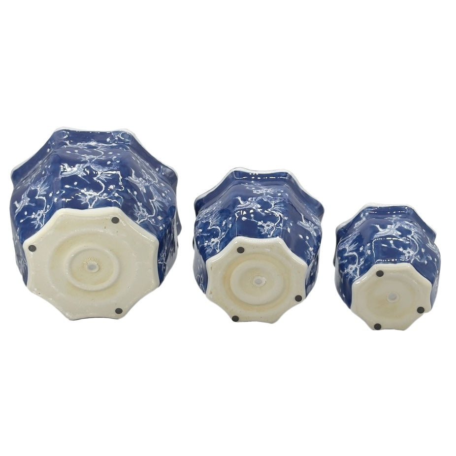 White ceramic planter with blue crane motif, fluted sides, and Chinoiserie pattern.