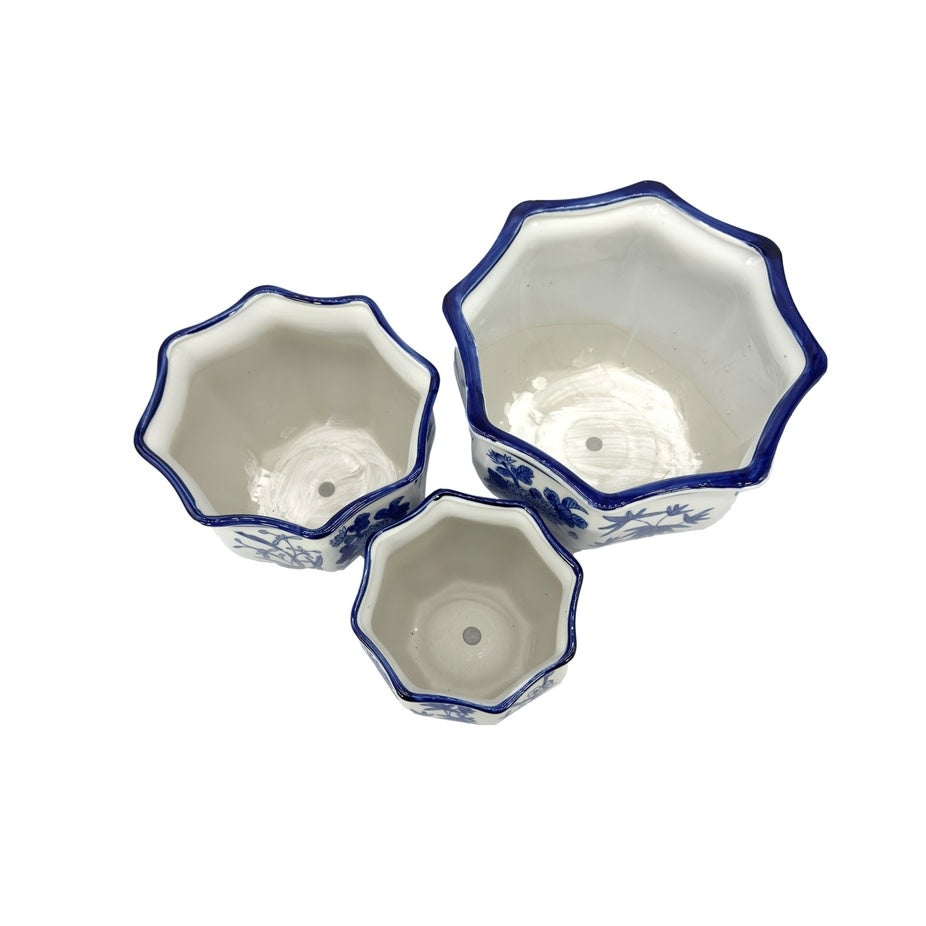 White ceramic planter with blue Chinoiserie fluting and round hexagonal silhouette.