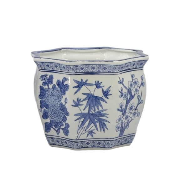 White ceramic planter pot with blue chinoiserie fluting and round hexagonal silhouette.