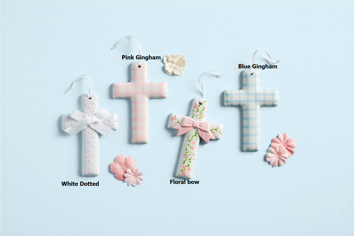 Hand-painted white ceramic cross with a ribbon hanger detail.