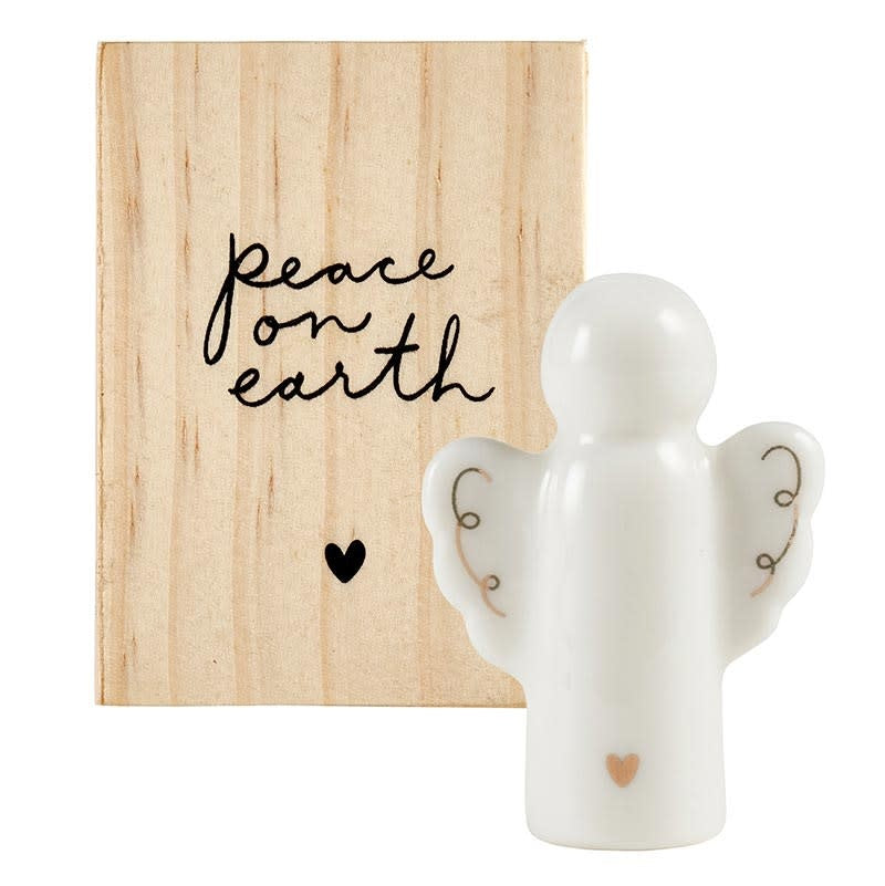 Ceramic angel figurine with gold embellishment inside a pine wood box.