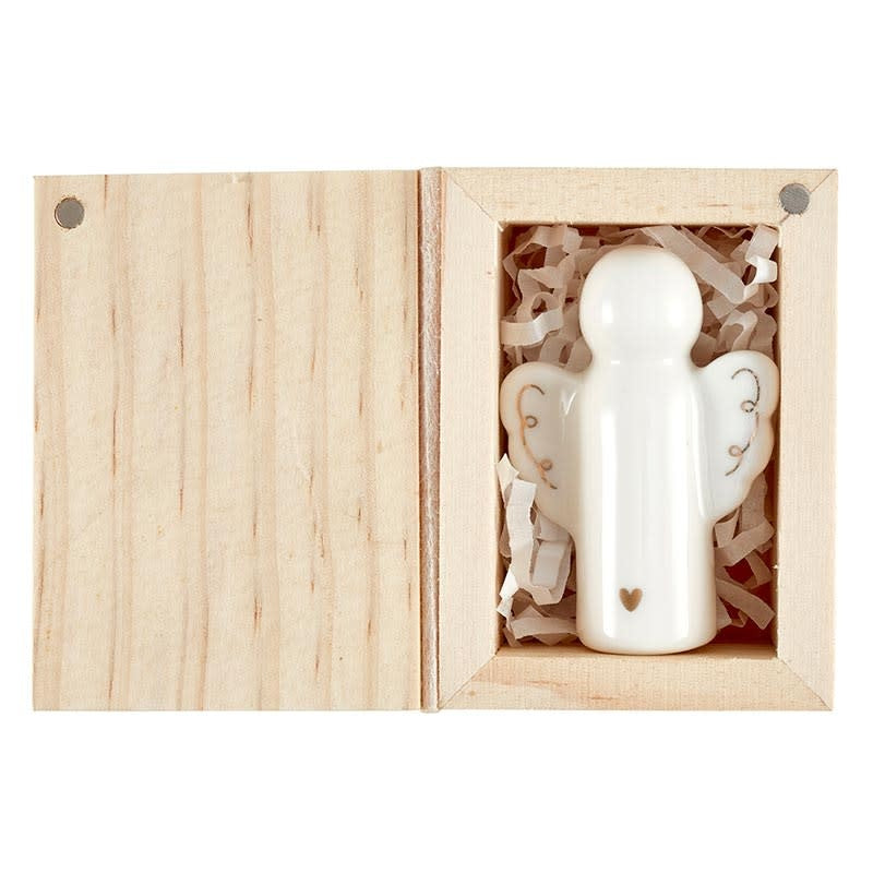 Ceramic angel figurine with gold embellishment inside a pine wood box.