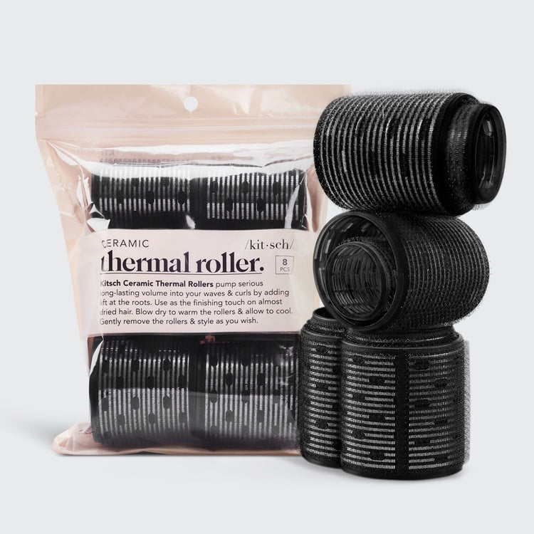 Eight ceramic thermal hair rollers in assorted sizes arranged on a white background.