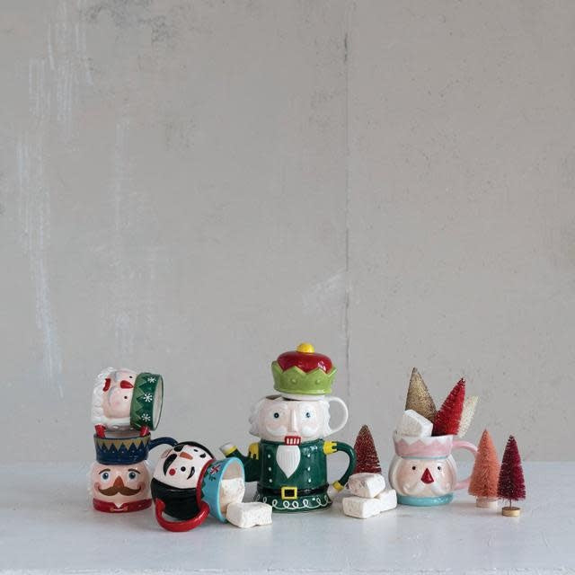 Ceramic mug with a detailed nutcracker illustration on the exterior.